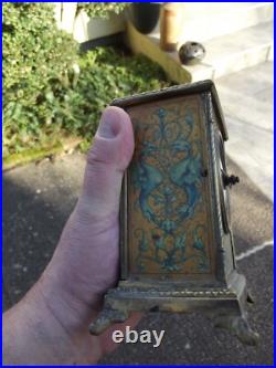 Ancienne pendule réveil d officier en bronze décors lithographier de chiméres