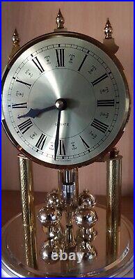 Horloge à poser Quartz à pendule rotatif, métal doré sous cloche Germany