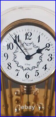 Horloge à poser Schmid mécanique pendule rotatif 8 jours métal doré sous cloche