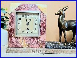 Horloge en marbre avec statue d'un animal sculpté en bronze