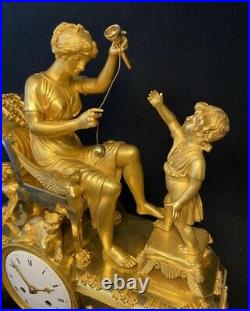 Pendule Empire La leçon de bilboquet en bronze doré. (French ormolu Clock)