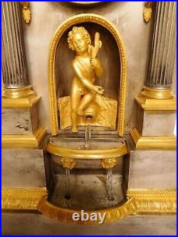 Pendule automate fontaine d'époque Restauration en bronze doré et argenté XIXe